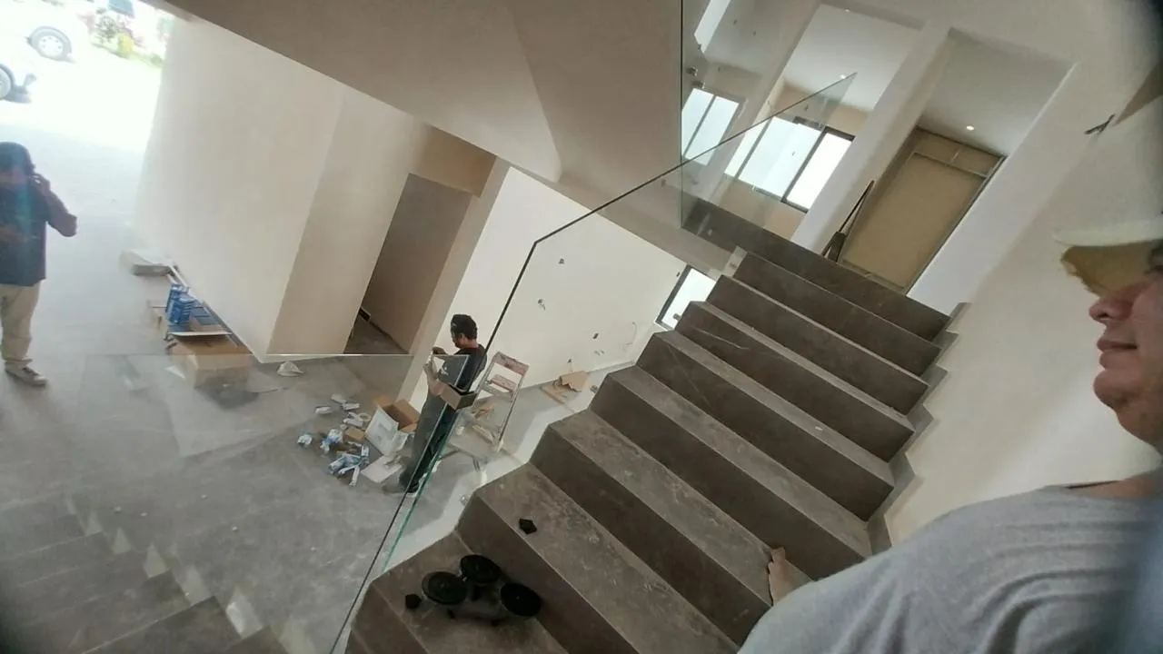 Instalación de barandal de cristal templado en escalera de mármol